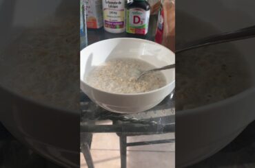 Healthy breakfast with oatmeal and almonds with a cup of tea