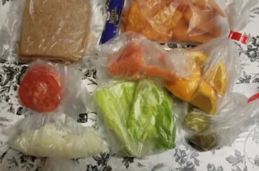 Lunch Ideas 51 turkey romaine lettuce tomatoes onions sandwich, carrots, oranges, pickles, chips