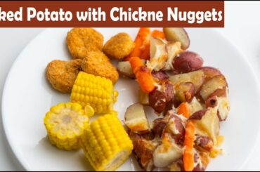 Dinner Baked potato with chicken  nuggets. Vegetable mix in oven. Low calories meal