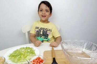 little boy making salad.healthy salad for kids.salad recipe.