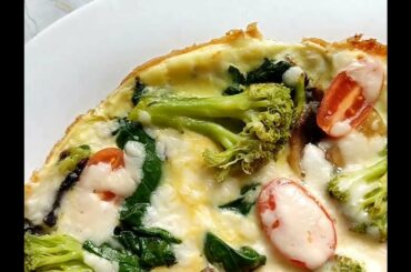 Omelette with spinach, mushrooms and broccoli. Fast and healthy breakfast recipe.