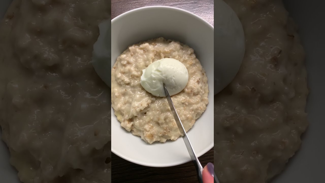 Savory porridge oatmeal with cheese and a boiled egg. A healthy breakfast idea. Savory porridge oatmeal with cheese and a boiled egg. A healthy breakfast idea.