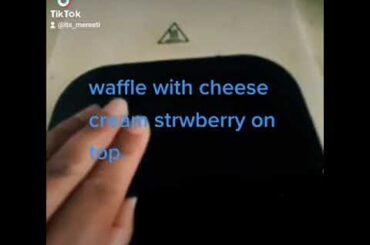 homemade healthy waffle with cheese cream strawberries on top.