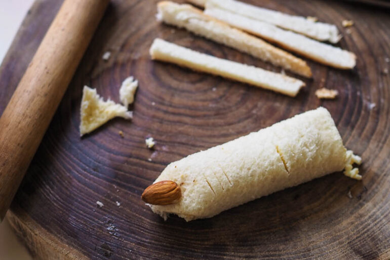 Halloween finger sandwich with an almond fingernail