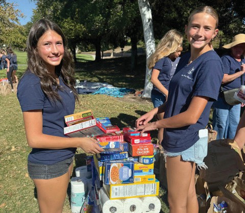 HELPING—National Charity League Ticktockers gather food donations for Manna. Courtesy photo